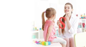 A little girl receiving speech therapy
