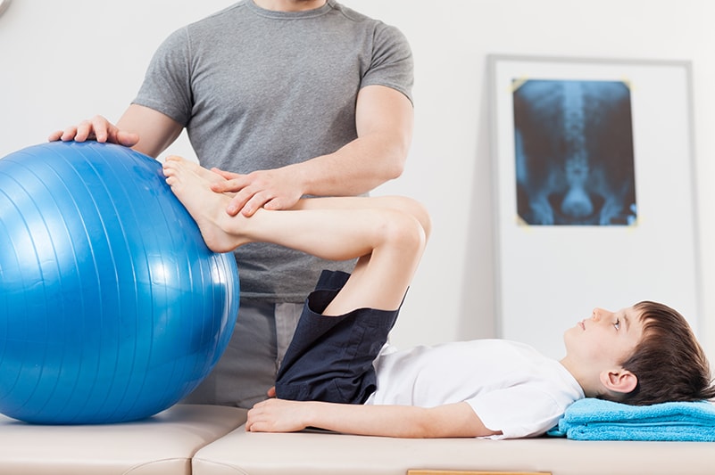 A boy receiving physical therapy