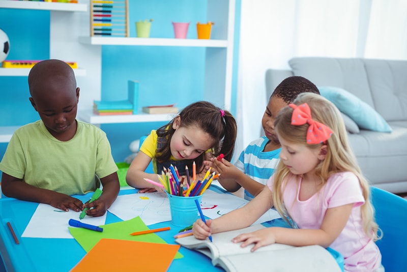 children doing crafts at a table