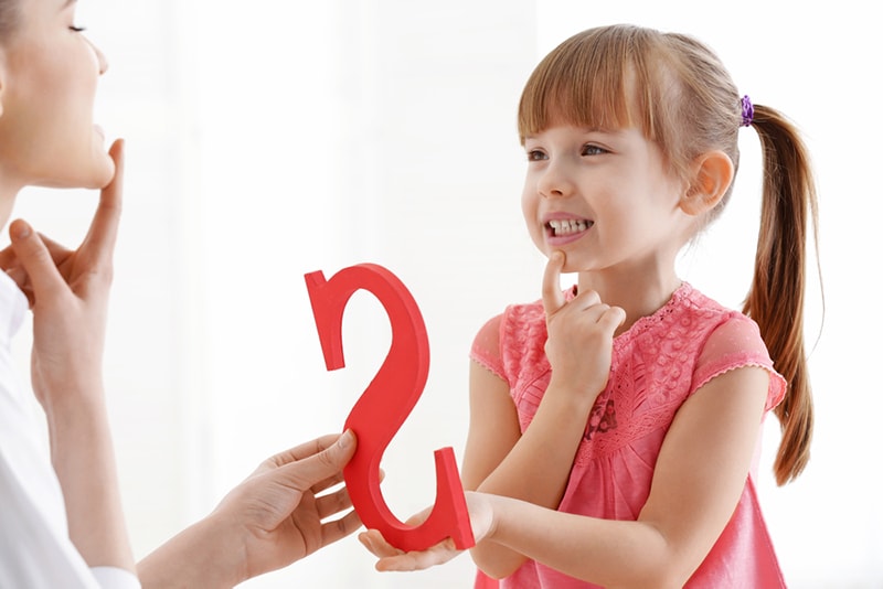 a little girl receiving speech therapy
